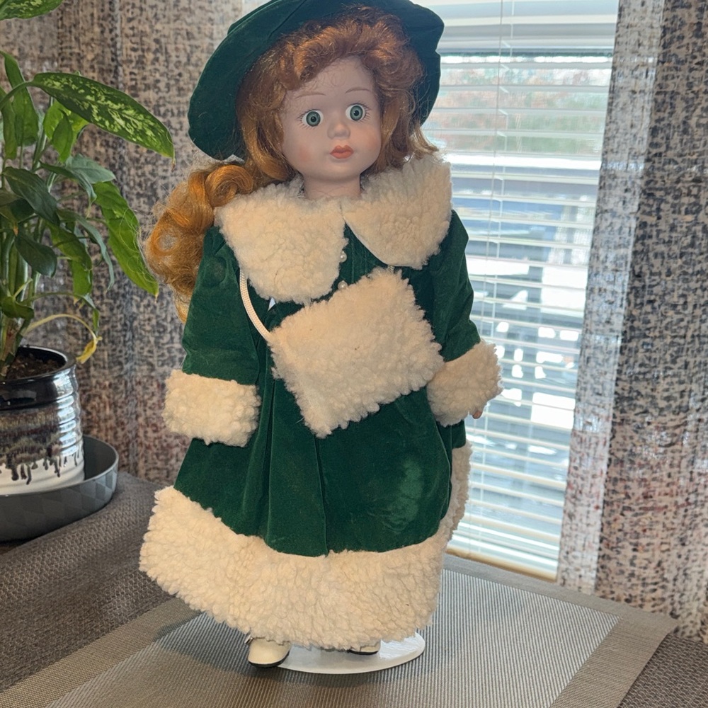 Vintage porcelain collector doll, with a green velvet dress. 16 inches tall